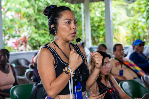 Raquel Nemo Andy Guiquita, a member of the Yutzu Group, in conversation with traditional Saamaka authorities